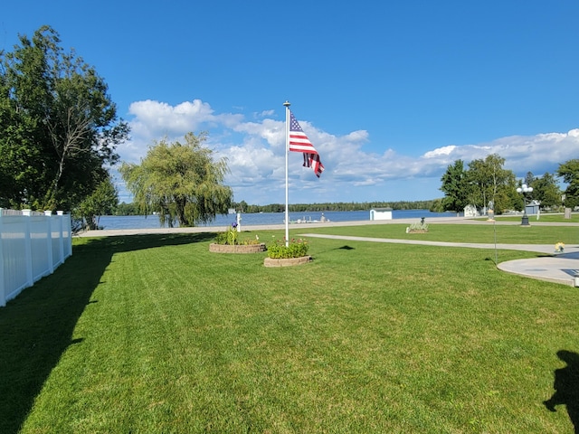 view of home's community featuring a yard and fence