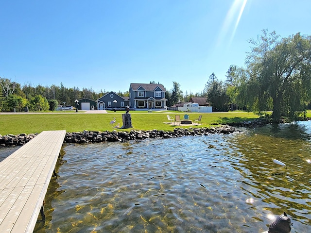 view of dock featuring a yard and a water view