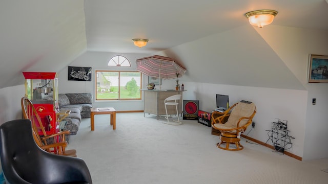 living area with baseboards, lofted ceiling, and carpet flooring