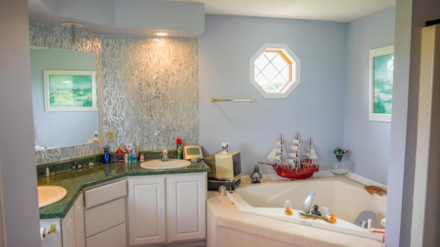 bathroom with double vanity, a garden tub, and a sink