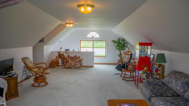 living area featuring baseboards, lofted ceiling, and carpet flooring