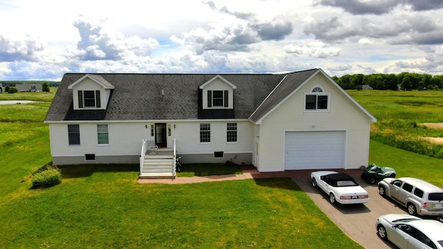 new england style home with driveway, roof with shingles, and a front yard