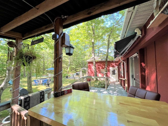 wooden terrace featuring outdoor dining area