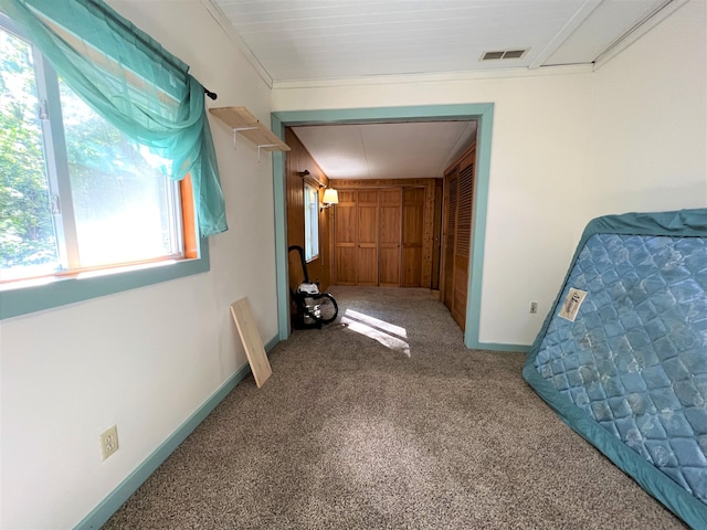 unfurnished bedroom with a closet, visible vents, baseboards, and carpet floors