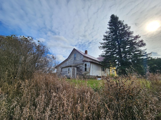 view of side of home featuring a chimney