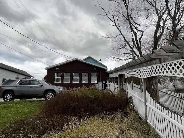 view of side of home featuring fence