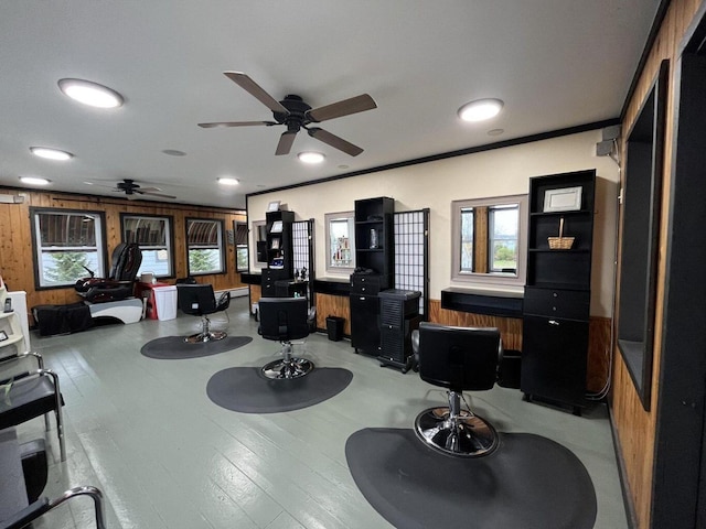 miscellaneous room with wooden walls, light wood-style flooring, and ornamental molding