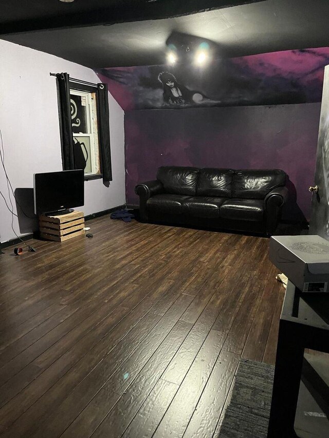 living area with vaulted ceiling and hardwood / wood-style flooring