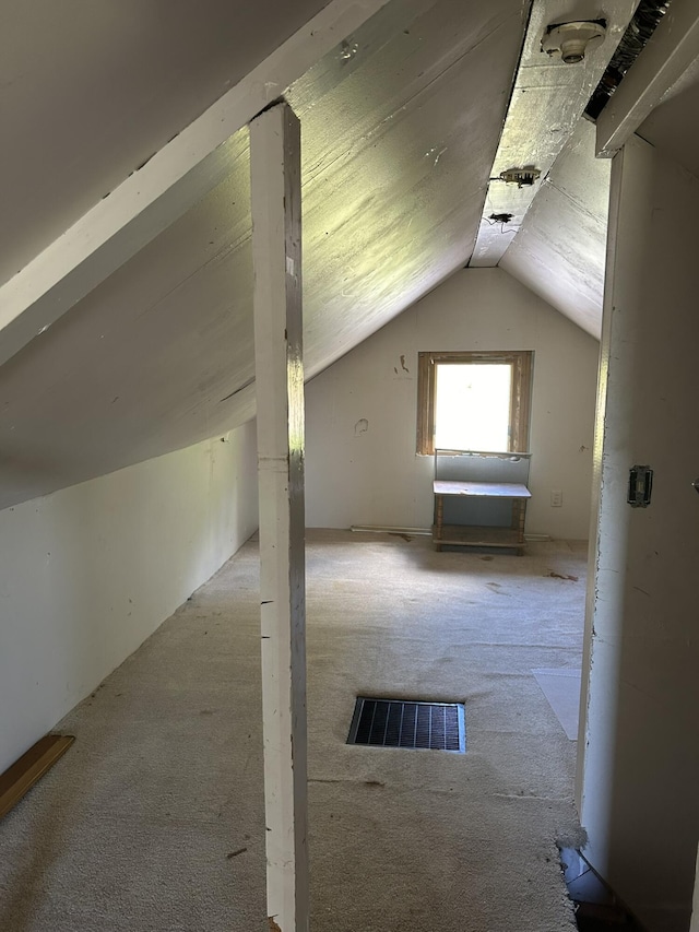 bonus room with visible vents, lofted ceiling, and carpet flooring