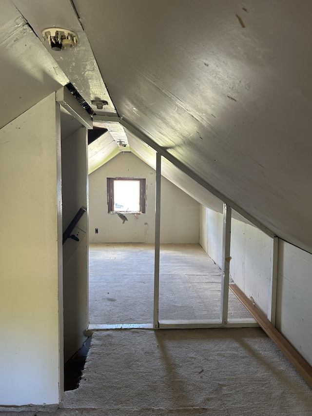 bonus room featuring lofted ceiling and carpet floors