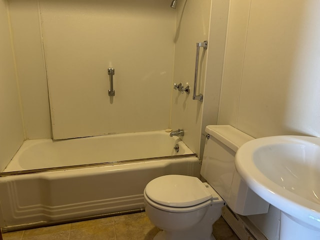 bathroom with tile patterned flooring, tub / shower combination, toilet, and a sink