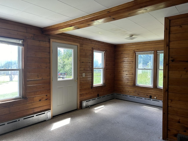 interior space featuring a wealth of natural light, beamed ceiling, visible vents, and a baseboard radiator