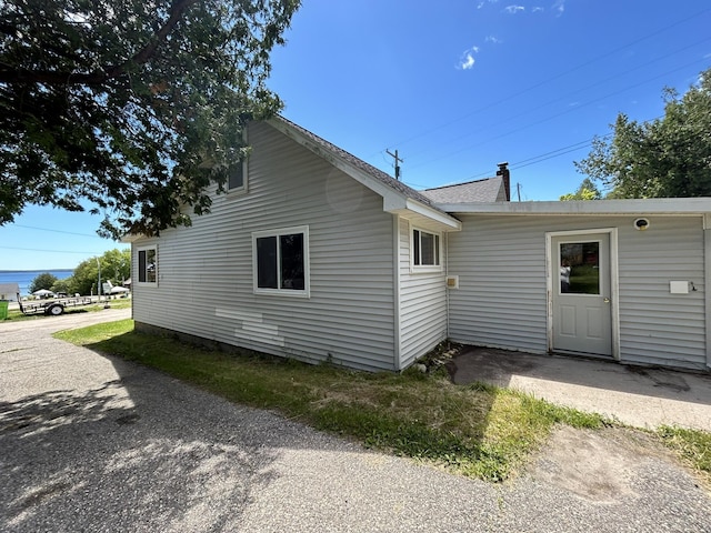 view of property exterior with a chimney