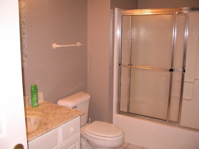 bathroom featuring toilet, vanity, and shower / bath combination with glass door