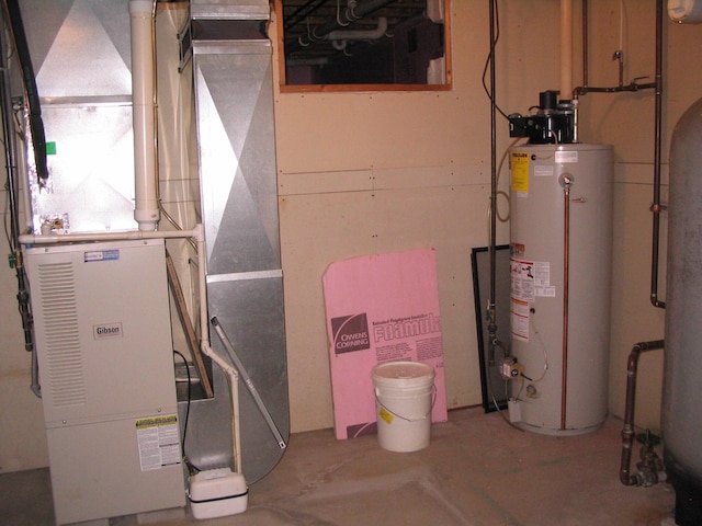 utility room featuring heating unit and water heater