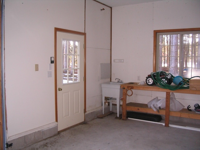 entryway with plenty of natural light, a workshop area, and wallpapered walls