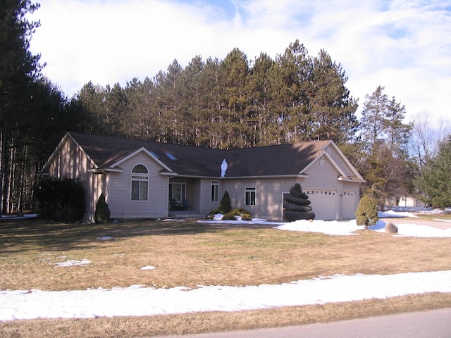 ranch-style home with an attached garage and a front lawn