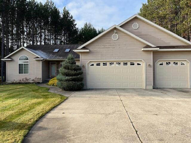 103 Misty Meadow Ct, Roscommon, MI 48653 - single story home with a front lawn, driveway, and an attached garage