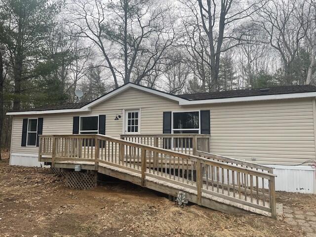 back of property featuring a wooden deck