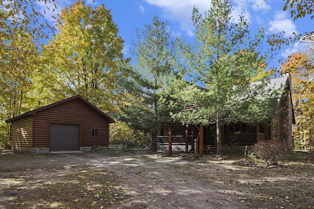 exterior space with covered porch and dirt driveway