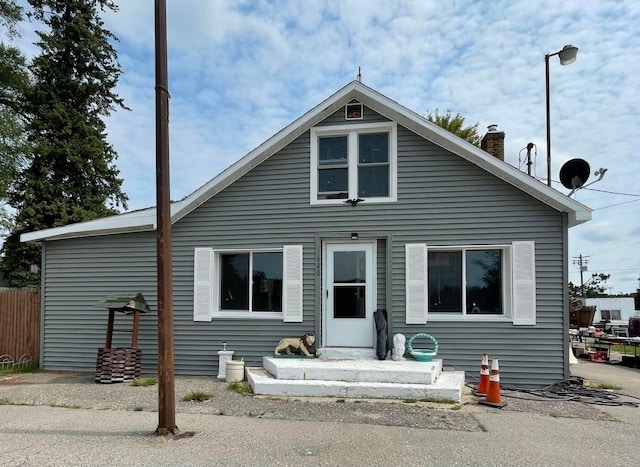 exterior space with fence and a chimney