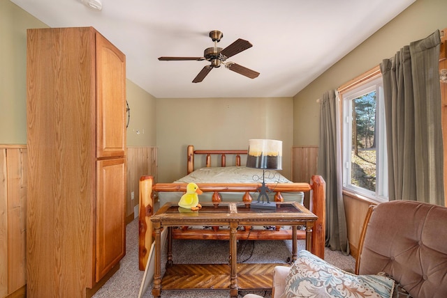 carpeted bedroom with wainscoting and wood walls