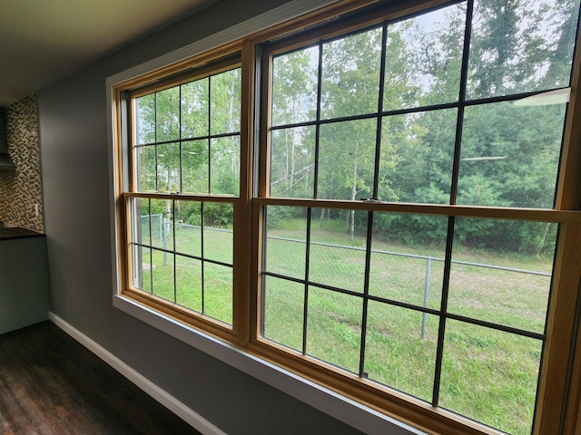 details featuring baseboards and wood finished floors