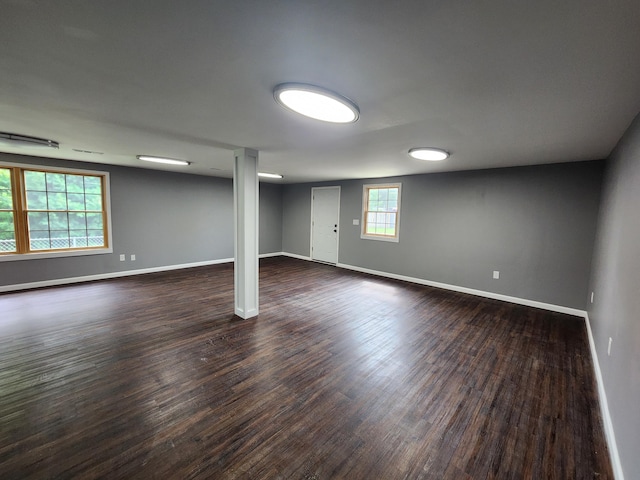 basement with baseboards and dark wood-style flooring