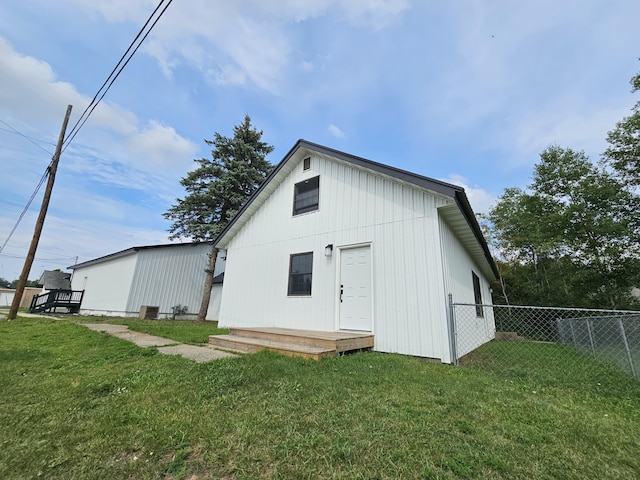 view of outbuilding featuring fence
