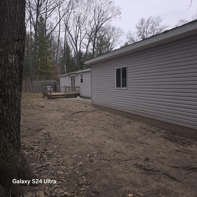 view of yard featuring a deck and fence