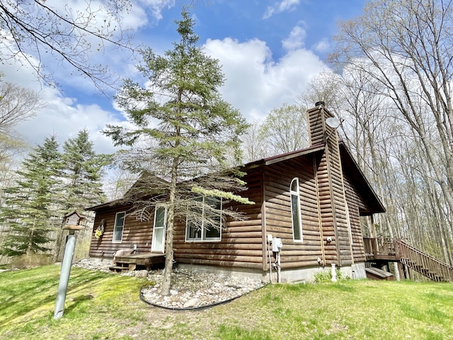 view of side of property featuring a lawn and a chimney