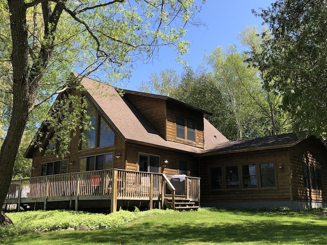 back of property featuring a yard and a wooden deck