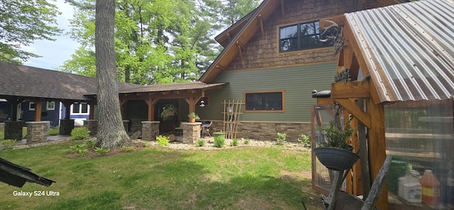 rear view of property featuring a yard