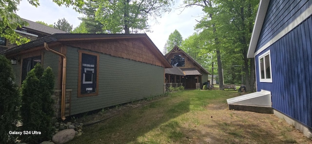 view of side of property featuring a yard