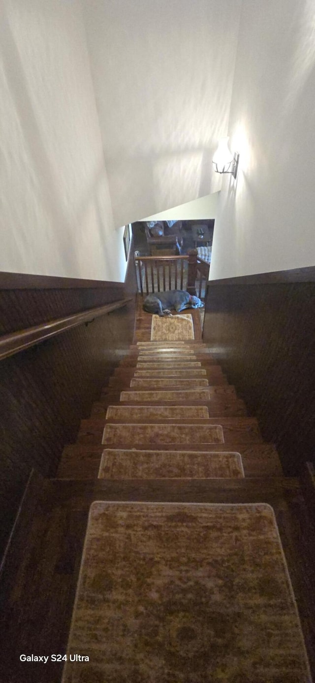 staircase featuring a wainscoted wall