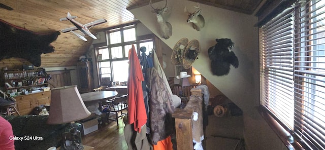 living area with lofted ceiling, wood ceiling, and wood finished floors