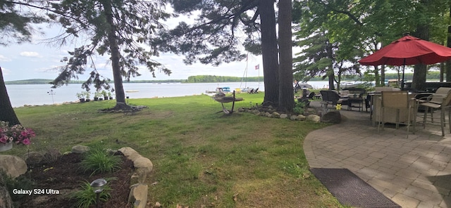 view of yard featuring a patio area and a water view