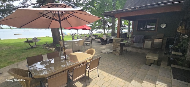 view of patio featuring outdoor dining space and a water view