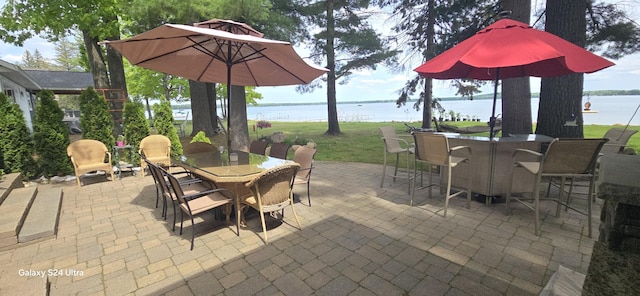 view of patio featuring outdoor dining space and a water view