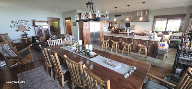 dining space featuring a bar and recessed lighting