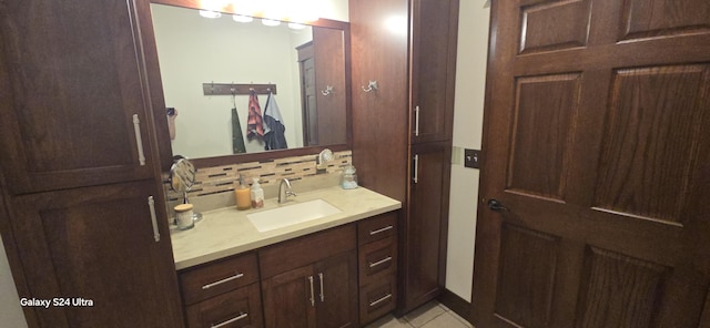 bathroom featuring tile patterned floors, tasteful backsplash, and vanity