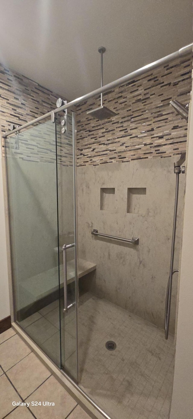 full bath with tile patterned floors and a shower stall