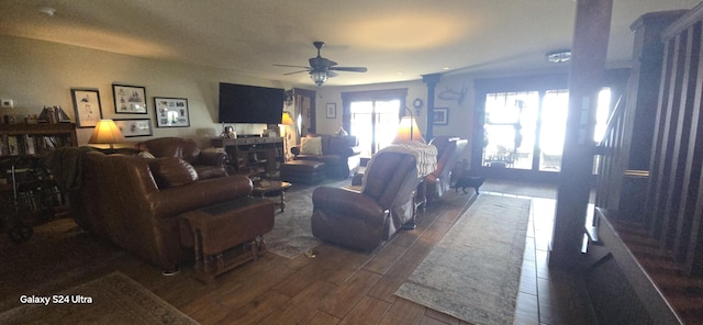 living area featuring dark wood finished floors and ceiling fan