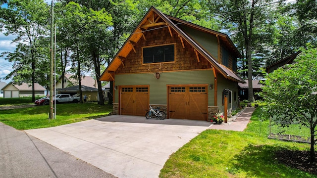 view of front of property with a front yard, a garage, and stone siding