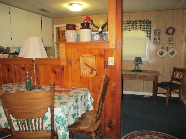 dining space with wood walls