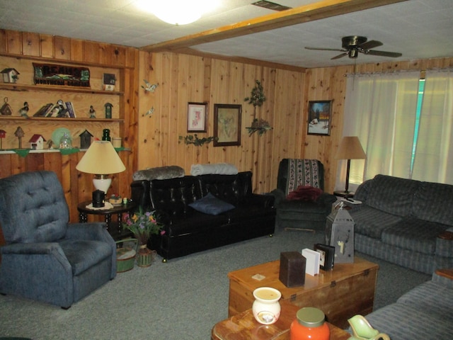 living area with carpet floors and wooden walls