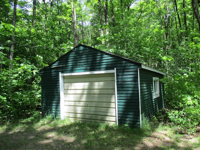 detached garage with a forest view