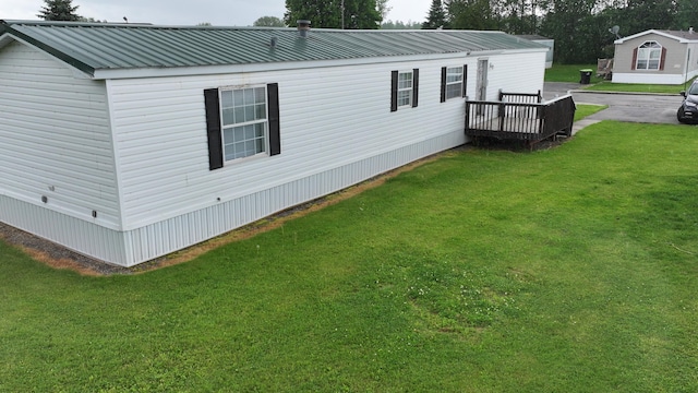 view of home's exterior featuring metal roof and a lawn