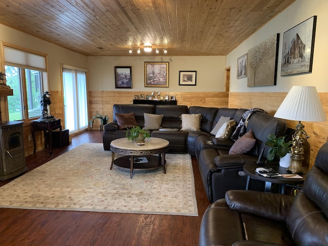 living area with a wainscoted wall, wooden ceiling, wooden walls, and wood finished floors