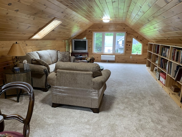 carpeted living room with wooden walls, vaulted ceiling with skylight, and wooden ceiling